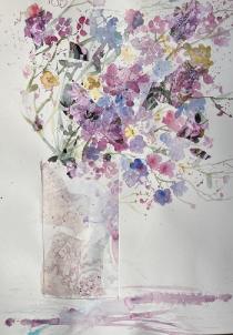 Pink, lavender and blue flowers with collage in a pale pink jug againsta white b