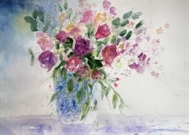 Red roses in a blue patterned jug