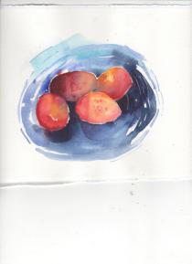 Four plums in a bright blue dish