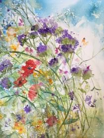 A mass of hedgerow flowers against ablue background with an Orange Tip butterfly