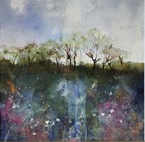 A tree lined horizon overlooking water and pink/mauve flowers