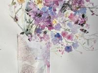 Pink, lavender and blue flowers with collage in a pale pink jug againsta white b