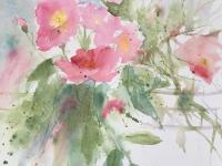 Pink roses in a mass with trailing stems and leaves