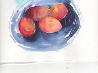 Plums in a blue dish Four plums in a bright blue dish