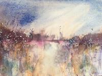 Across teh Fen Mauve distant bank with reeds in the foreground