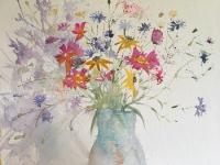 Meadow Bouquet Wild flowers in a mass of colour in a pale blue jug